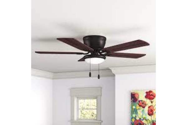 A ceiling fan with a light hanging from the ceiling in a room with a window and a painting on the wall.